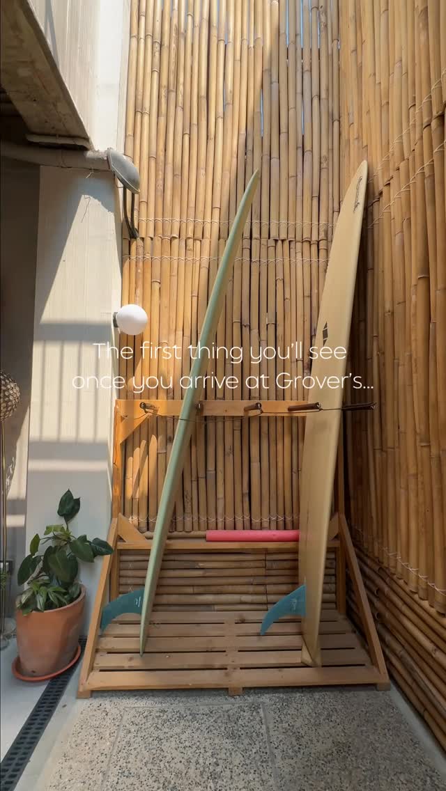 Surfboards racked at Grover's entrance — the first thing you'll see when you arrive