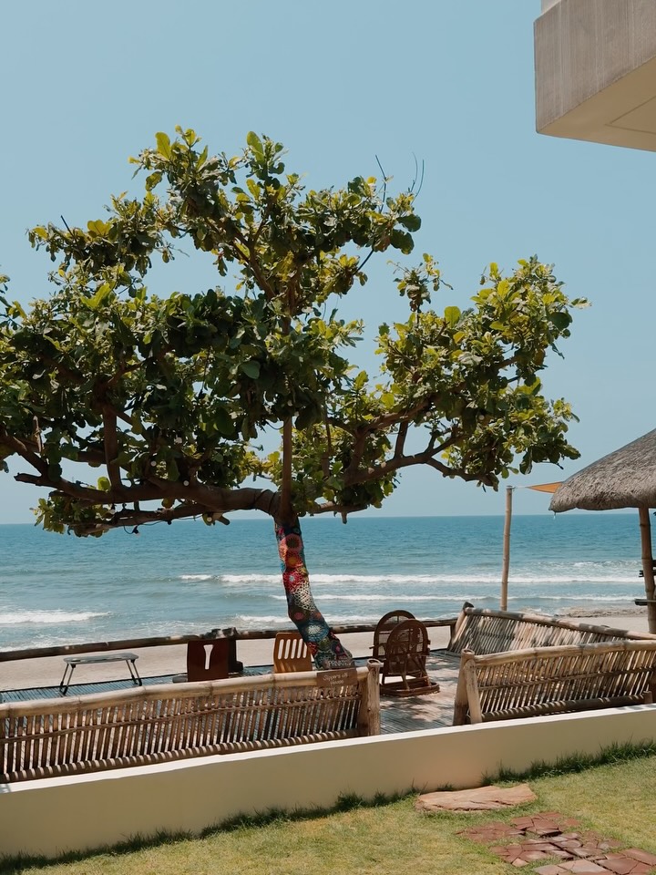 Grover's balcony view with thatched nipa roof and beach below